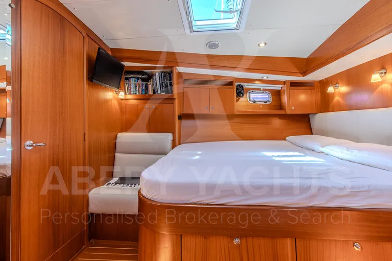 Satori Yacht Photos Pics Luxurious cabin interior of 2005 Farr 64 yacht with wood finish and skylight.