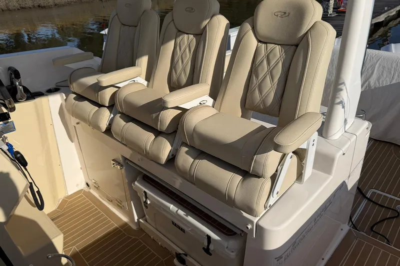  Yacht Photos Pics 2019 Regal 33 SAV boat interior with beige cushioned seats and armrests.