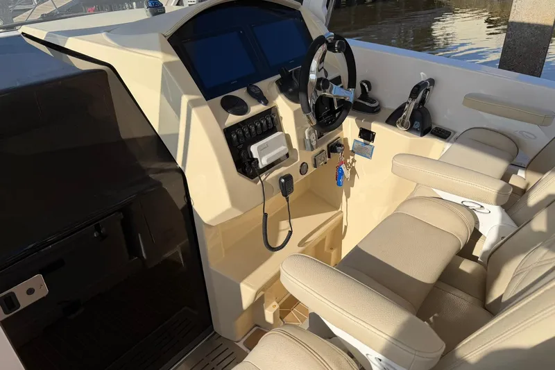 Yacht Photos Pics 2019 Regal 33 SAV boat cockpit with steering wheel and control panel.