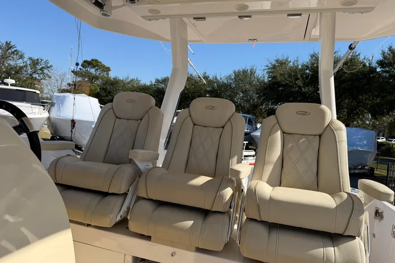  Yacht Photos Pics 2019 Regal 33 SAV boat with three luxurious beige seats under a canopy.