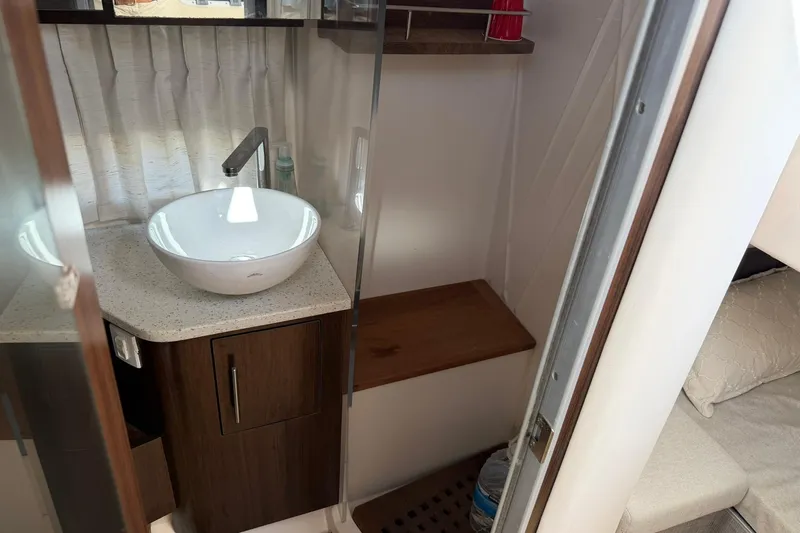  Yacht Photos Pics 2019 Regal 33 SAV boat interior with modern sink and wooden cabinetry.