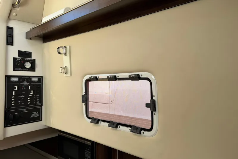  Yacht Photos Pics Interior view of 2019 Regal 33 SAV boat with control panels and window.