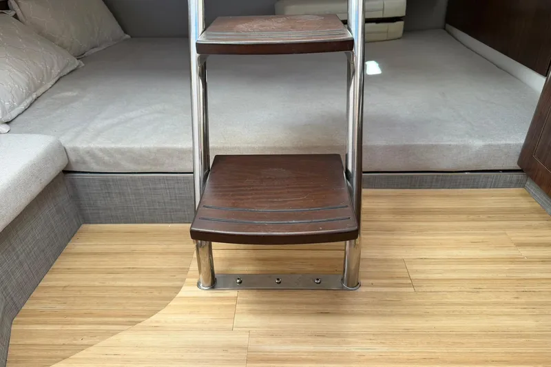  Yacht Photos Pics Interior of 2019 Regal 33 SAV boat with wooden steps and cozy bedding.