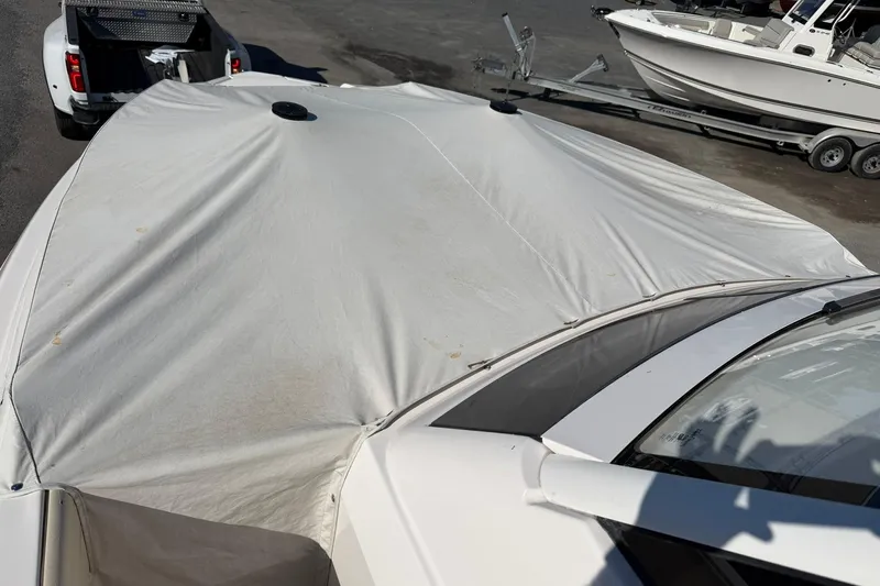  Yacht Photos Pics 2019 Regal 33 SAV boat covered, parked on trailer near other boats.