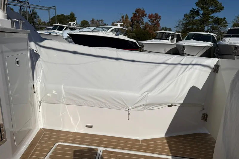  Yacht Photos Pics 2019 Regal 33 SAV boat deck with protective cover, surrounded by other boats.