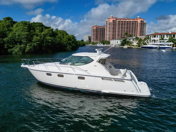  Yacht Photos Pics 2008 Tiara Yachts 3900 Sovran cruising on a scenic waterway with lush greenery and buildings.