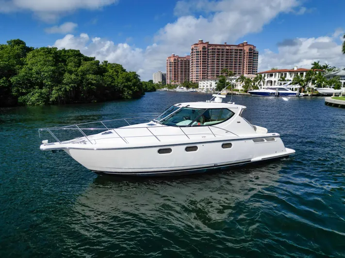  Yacht Photos Pics 2008 Tiara Yachts 3900 Sovran cruising on a scenic waterway with buildings in the background.