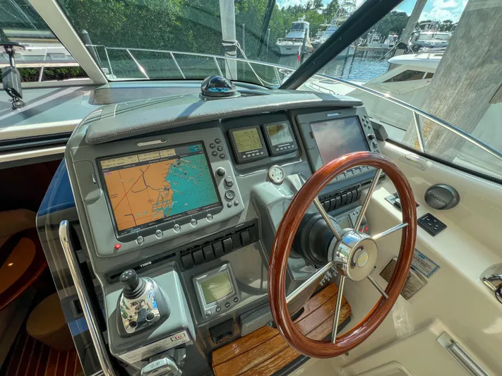  Yacht Photos Pics 2008 Tiara Yachts 3900 Sovran helm with navigation screens and wooden steering wheel.