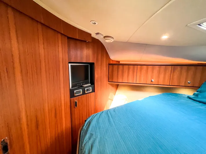  Yacht Photos Pics 2008 Tiara Yachts 3900 Sovran cabin with wood paneling and cozy bed.