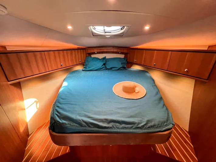  Yacht Photos Pics Luxurious cabin interior of 2008 Tiara Yachts 3900 Sovran with cozy bed and wooden accents.