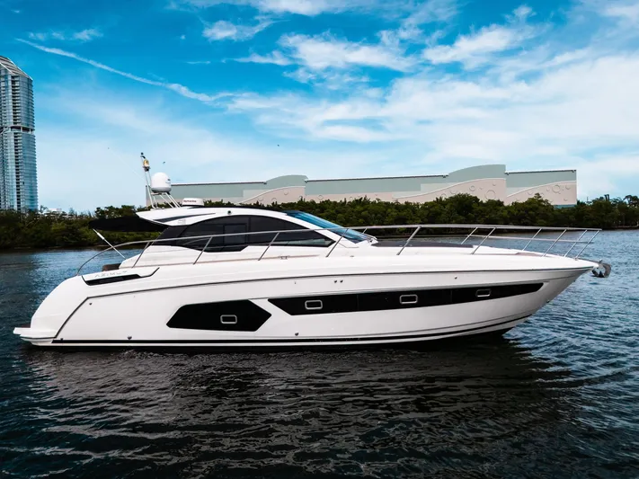 Amici Yacht Photos Pics 2019 Azimut Atlantis 43 yacht on water, sleek design, modern architecture in background.