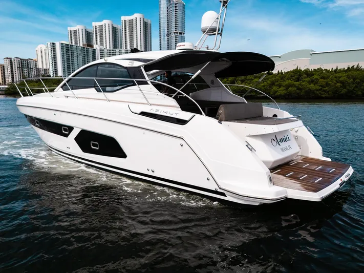 Amici Yacht Photos Pics 2019 Azimut Atlantis 43 yacht cruising near city skyline.