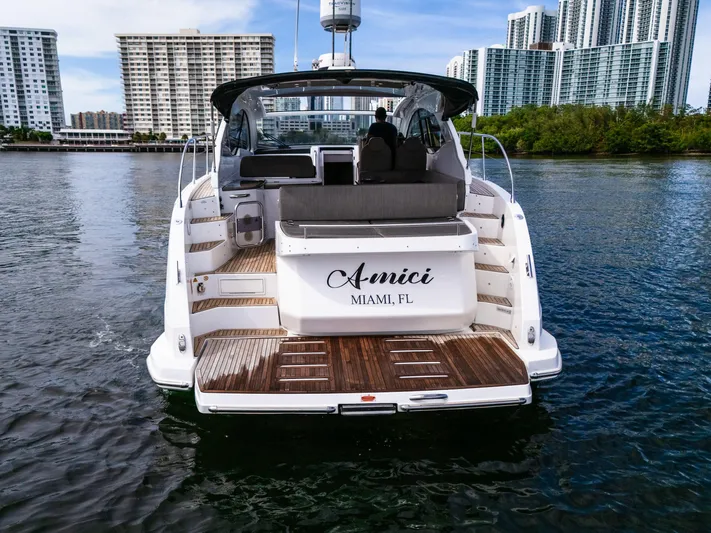 Amici Yacht Photos Pics Azimut Atlantis 43 yacht, 2019 model, docked in Miami with city skyline backdrop.