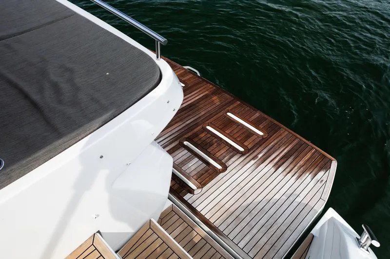 Amici Yacht Photos Pics 2019 Azimut Atlantis 43 yacht with elegant wooden deck by the water.