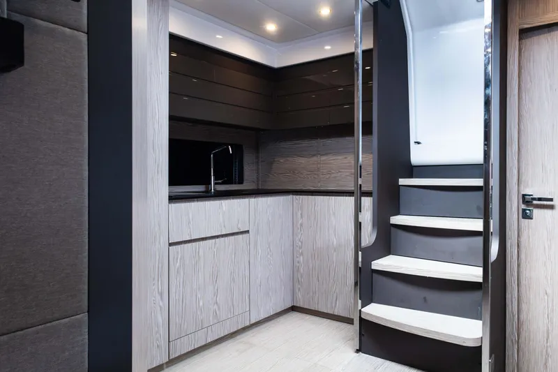 Amici Yacht Photos Pics Modern interior of 2019 Azimut Atlantis 43 yacht with sleek kitchen and staircase.