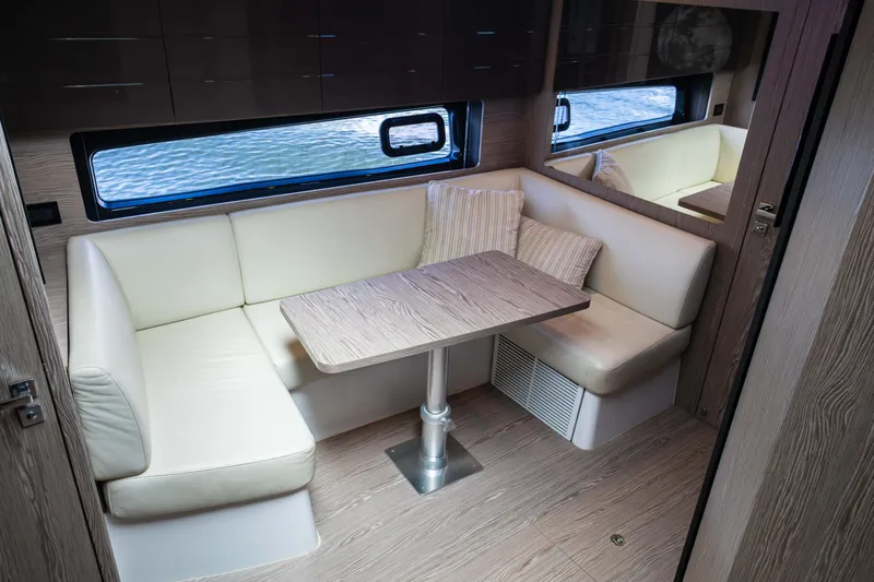 Amici Yacht Photos Pics Interior of 2019 Azimut Atlantis 43 yacht with cozy seating and wooden table.