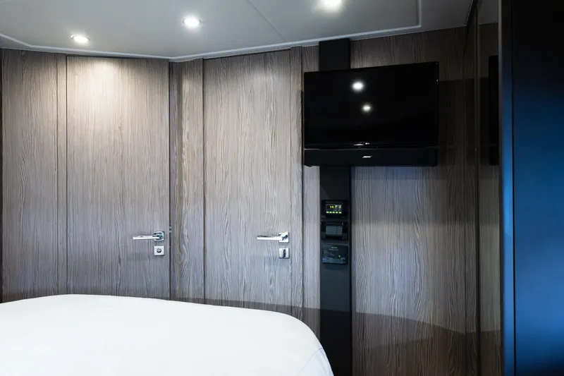 Amici Yacht Photos Pics Interior of 2019 Azimut Atlantis 43 yacht with modern wood paneling and wall-mounted TV.