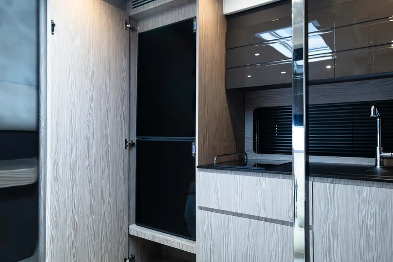 Amici Yacht Photos Pics Modern kitchen interior of 2019 Azimut Atlantis 43 yacht, featuring sleek cabinetry and fixtures.