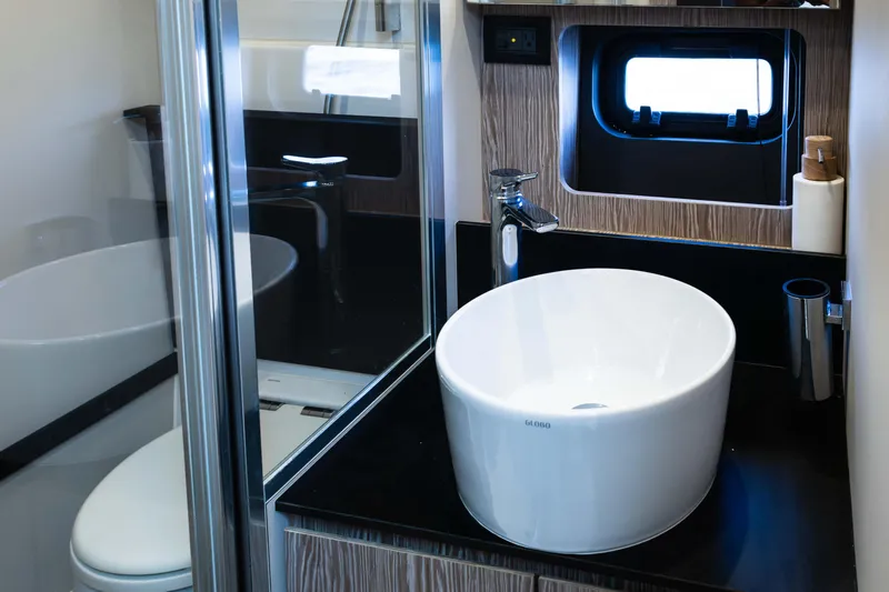 Amici Yacht Photos Pics Luxurious bathroom in 2019 Azimut Atlantis 43 yacht with modern sink and window.