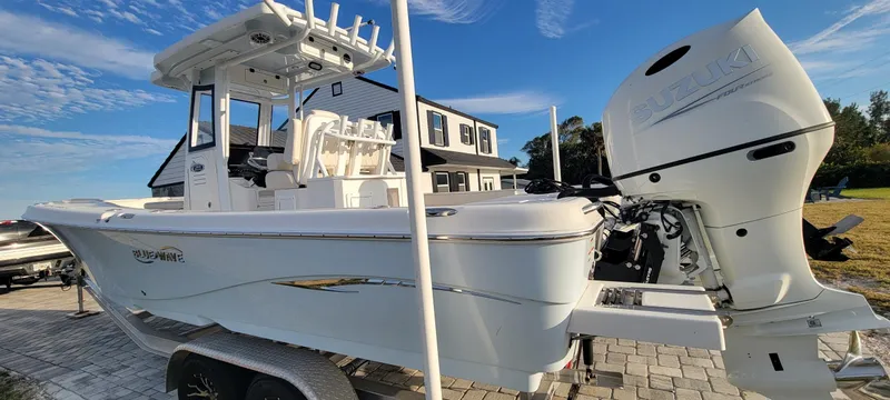  Yacht Photos Pics 2023 Blue Wave 2800 Makaira boat on trailer, parked outdoors under blue sky.