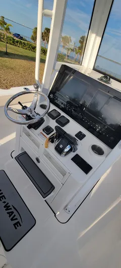  Yacht Photos Pics 2023 Blue Wave 2800 Makaira boat console with steering wheel and controls.