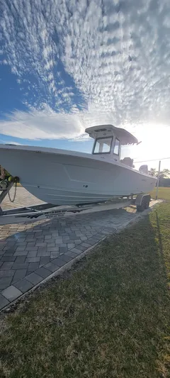  Yacht Photos Pics 2023 Blue Wave 2800 Makaira boat on trailer under a partly cloudy sky.