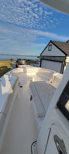  Yacht Photos Pics 2023 Blue Wave 2800 Makaira boat docked near a house with scenic sky.