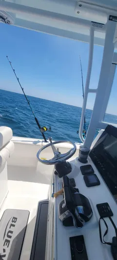  Yacht Photos Pics 2023 Blue Wave 2800 Makaira boat interior with fishing rods and ocean view.