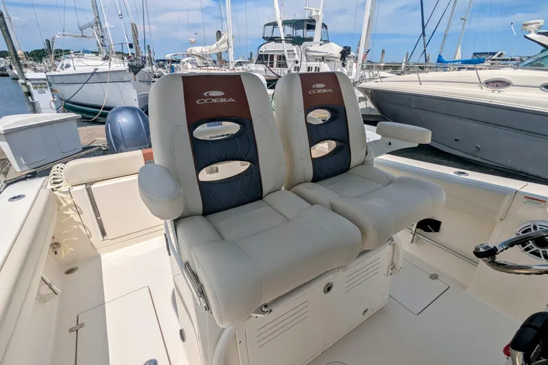  Yacht Photos Pics 2023 Cobia 280 Center Console boat with dual seats at marina.