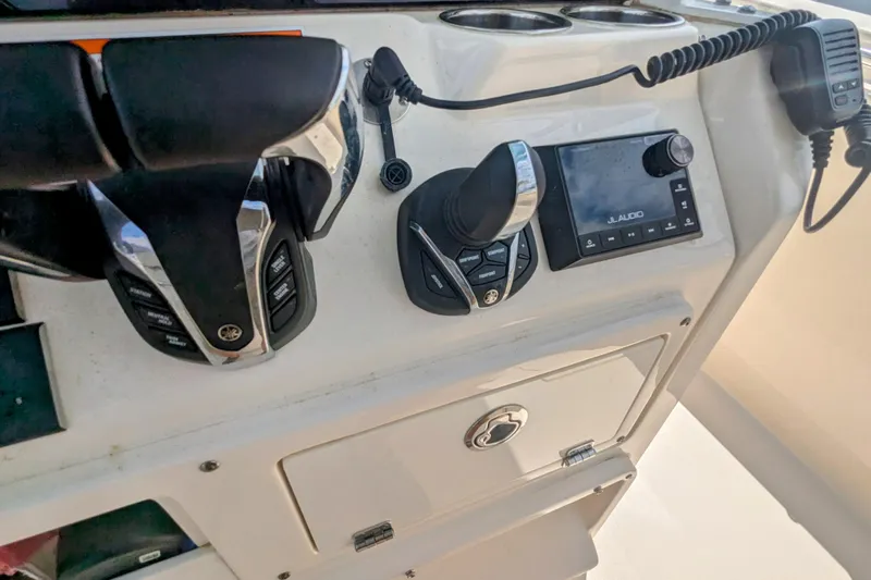  Yacht Photos Pics Control panel of 2023 Cobia 280 Center Console boat with audio system and throttle controls.