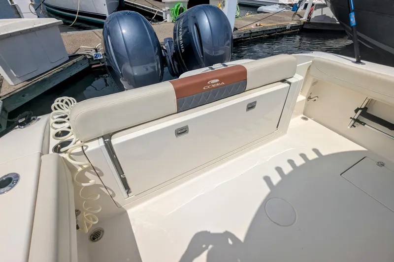  Yacht Photos Pics 2023 Cobia 280 Center Console boat with dual Yamaha engines at a marina.