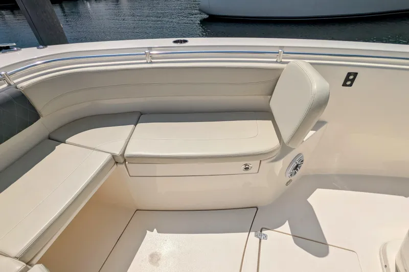  Yacht Photos Pics 2023 Cobia 280 Center Console boat seating area with cushioned benches and speaker.