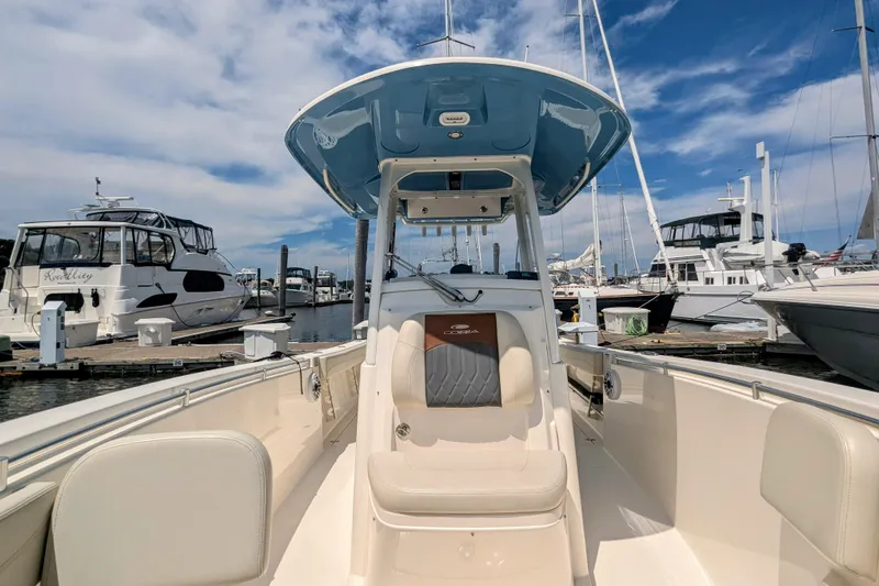  Yacht Photos Pics 2023 Cobia 280 Center Console boat docked at marina under blue sky.