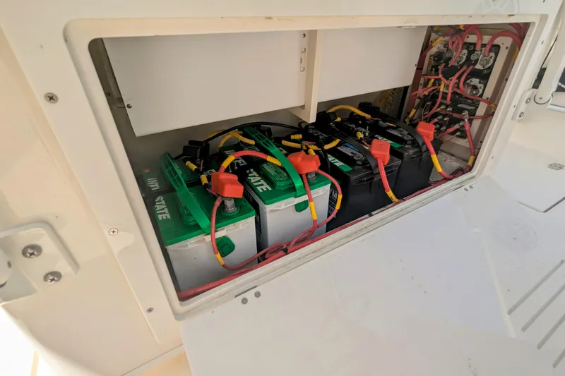  Yacht Photos Pics 2023 Cobia 280 Center Console battery compartment with multiple batteries and wiring.