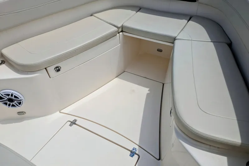  Yacht Photos Pics 2023 Cobia 280 Center Console boat seating area with storage compartments.