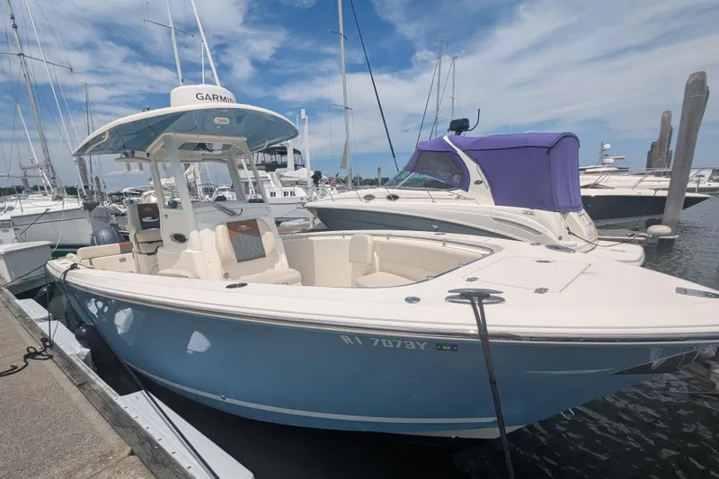  Yacht Photos Pics 2023 Cobia 280 Center Console boat docked at marina under clear blue sky.