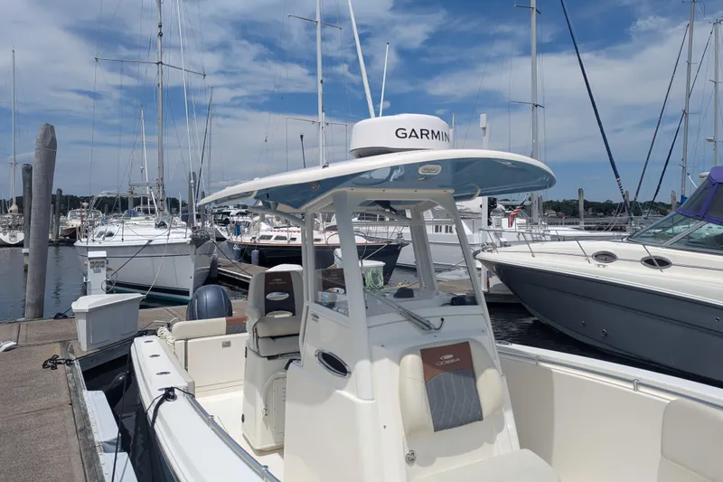  Yacht Photos Pics 2023 Cobia 280 Center Console boat docked at a marina with clear skies.