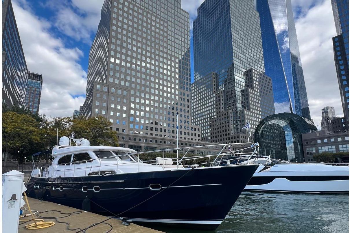 Luxury Elling E6 yacht docked in urban marina, skyscrapers in background, 2026 model.