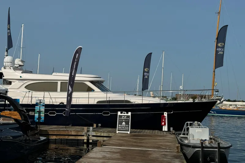  Yacht Photos Pics 2026 Elling E6 yacht docked at marina with flags and clear sky.