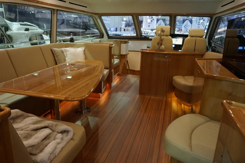  Yacht Photos Pics Luxurious interior of 2026 Elling E6 yacht with elegant wood finishes and plush seating.