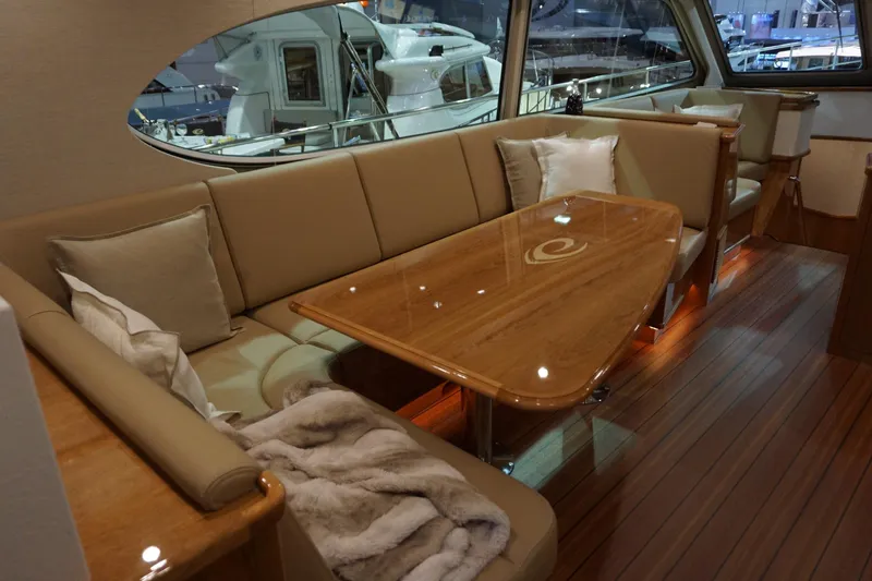  Yacht Photos Pics Luxurious interior of 2026 Elling E6 yacht with elegant seating and wooden table.
