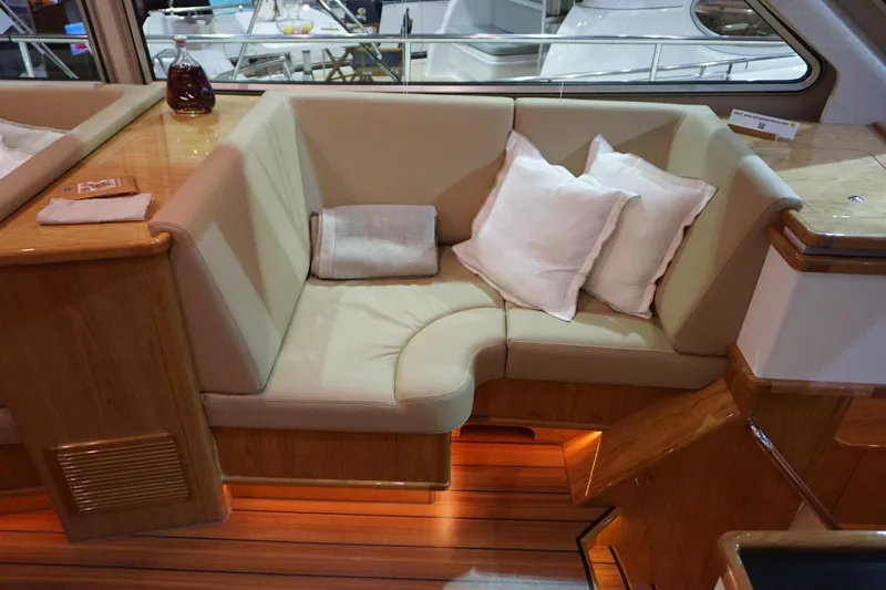  Yacht Photos Pics Luxurious interior of 2026 Elling E6 yacht with cozy seating and elegant wood finish.