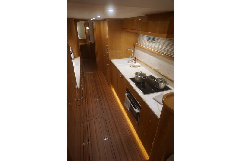  Yacht Photos Pics Luxurious 2026 Elling E6 yacht kitchen with modern appliances and elegant wood finish.