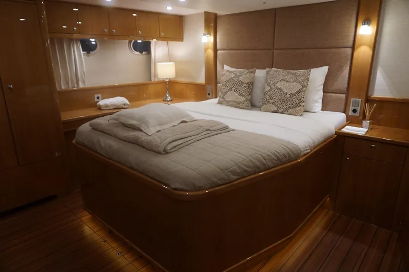  Yacht Photos Pics Luxurious bedroom interior of 2026 Elling E6 yacht with elegant wood finishes.