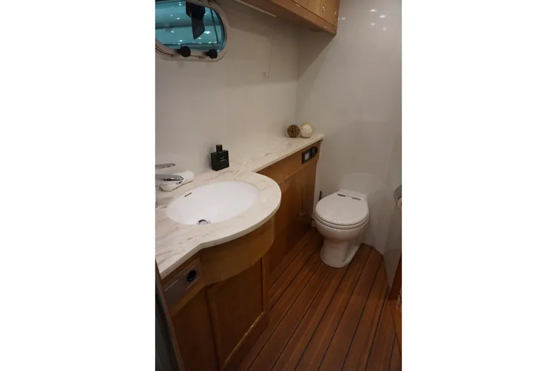  Yacht Photos Pics Luxurious bathroom in 2026 Elling E6 yacht with wooden flooring and modern fixtures.