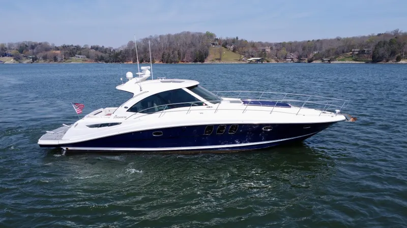  Yacht Photos Pics 2006 Sea Ray 48 Sundancer yacht cruising on a serene lake.