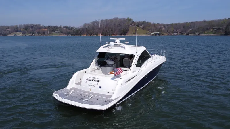  Yacht Photos Pics 2006 Sea Ray 48 Sundancer yacht cruising on a serene lake.