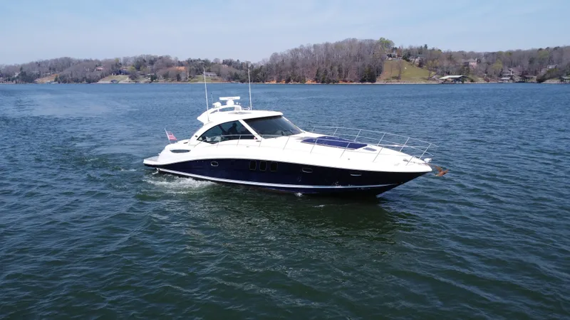  Yacht Photos Pics 2006 Sea Ray 48 Sundancer yacht cruising on a serene lake.