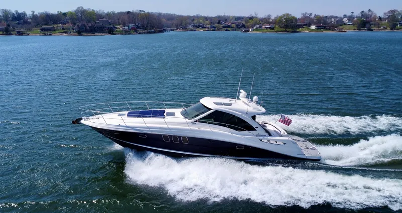  Yacht Photos Pics 2006 Sea Ray 48 Sundancer yacht cruising on a scenic lake.