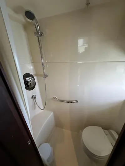  Yacht Photos Pics Bathroom interior of 2006 Sea Ray 48 Sundancer yacht, featuring shower and toilet.